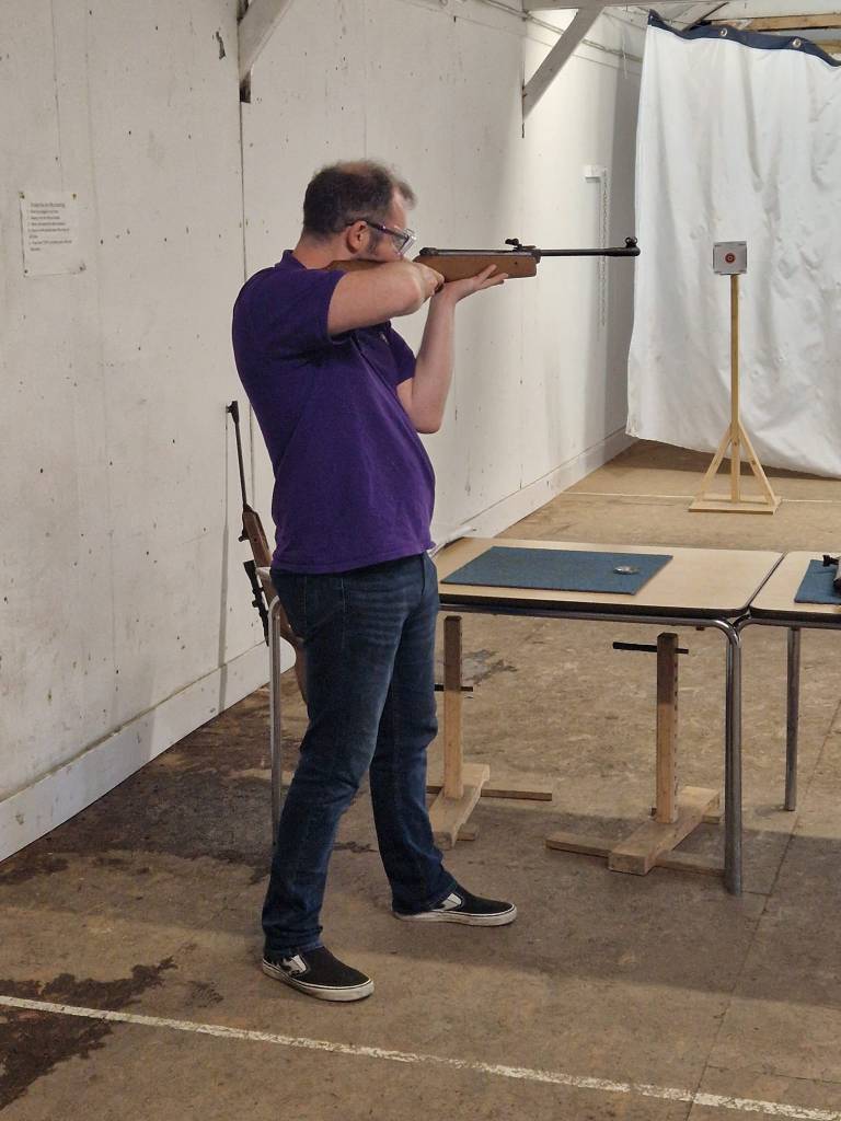 Scout Leader Richard giving a demonstration at air rifle shooting