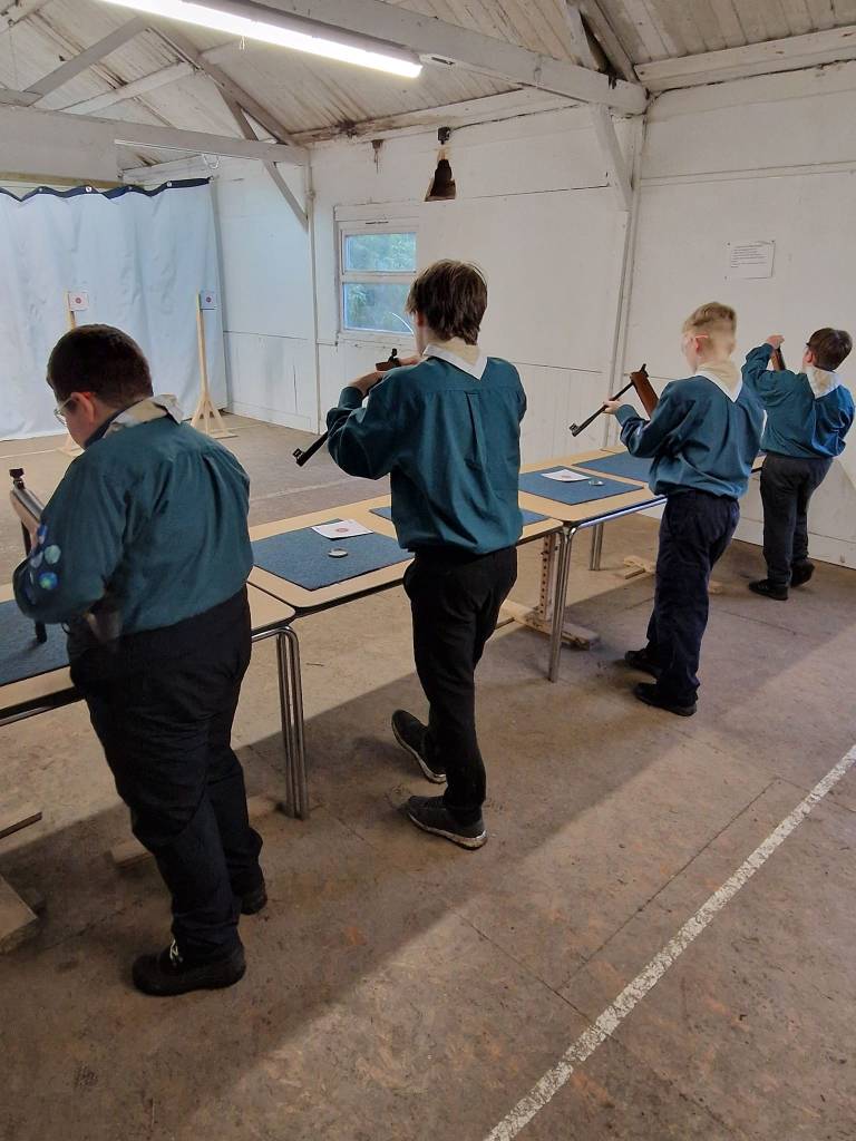 4 Scouts having a go at air rifle shooting